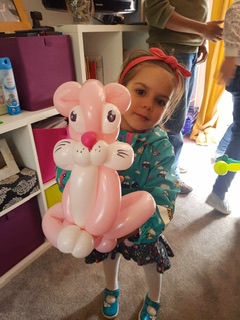 girl holding pink cat balloon model in Stafford